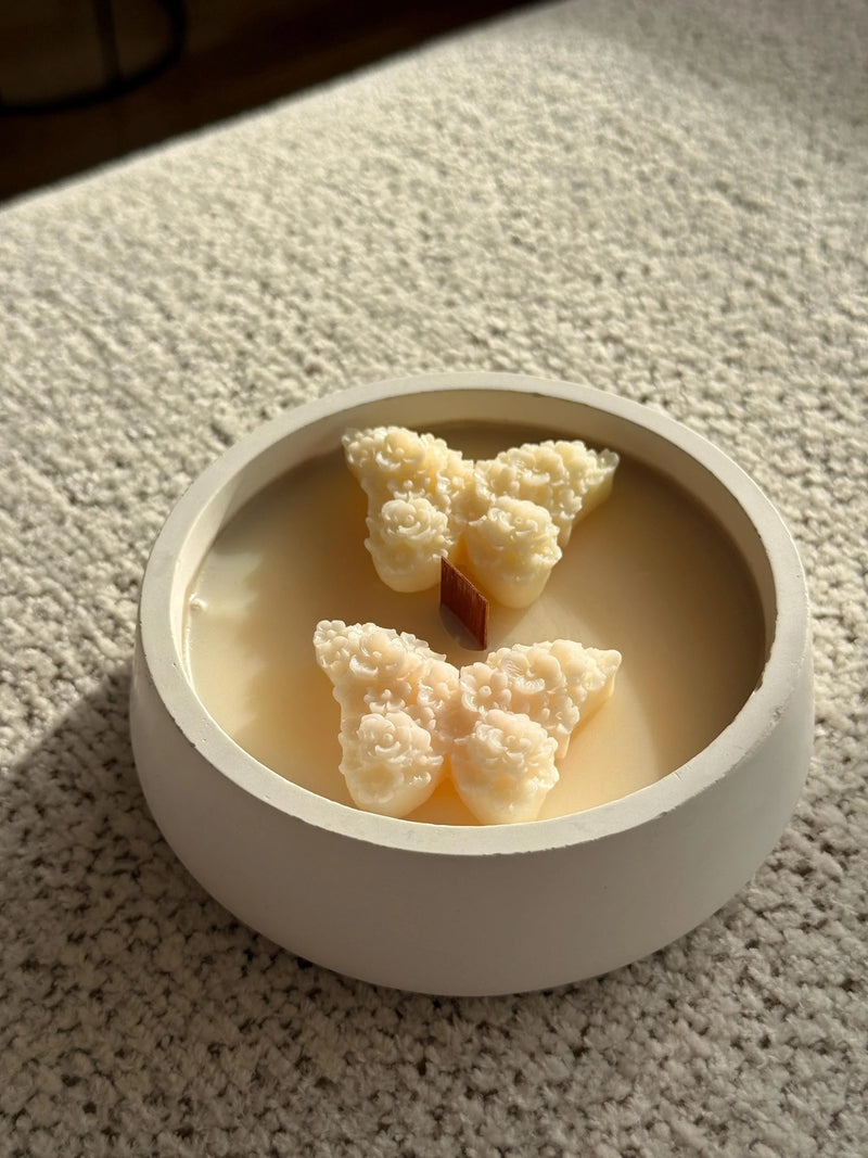 Handmade soy candle with floral wax melts in a white ceramic bowl, Scandinavian home decor