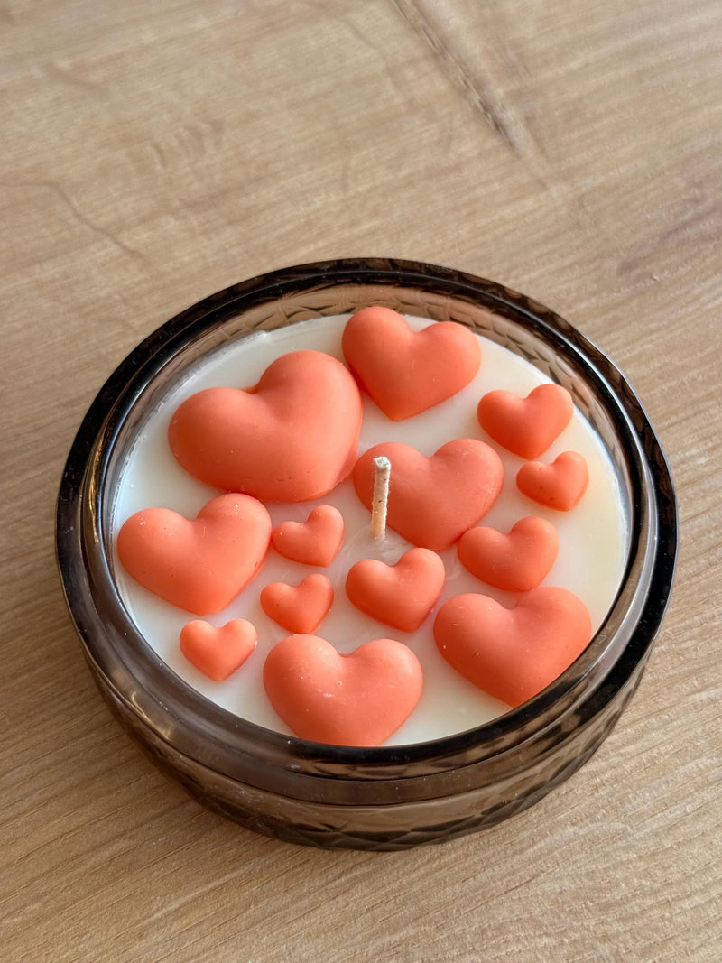 Handmade soy candle with coral hearts in amber glass jar, Scandinavian home décor