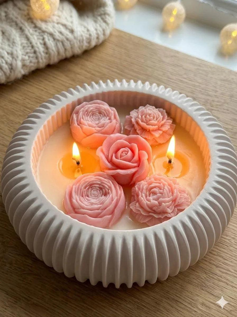 Handmade soy candle with pink rose blooms in white ceramic dish, cozy Scandinavian home decor