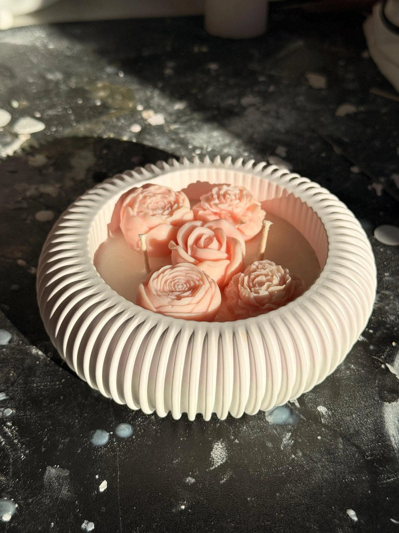 Handmade soy candle with pink rose blooms in a white ribbed ceramic bowl, Scandinavian home decor