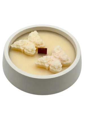 Handmade soy candle with floral wax accents in a minimalist concrete bowl, Scandinavian home décor