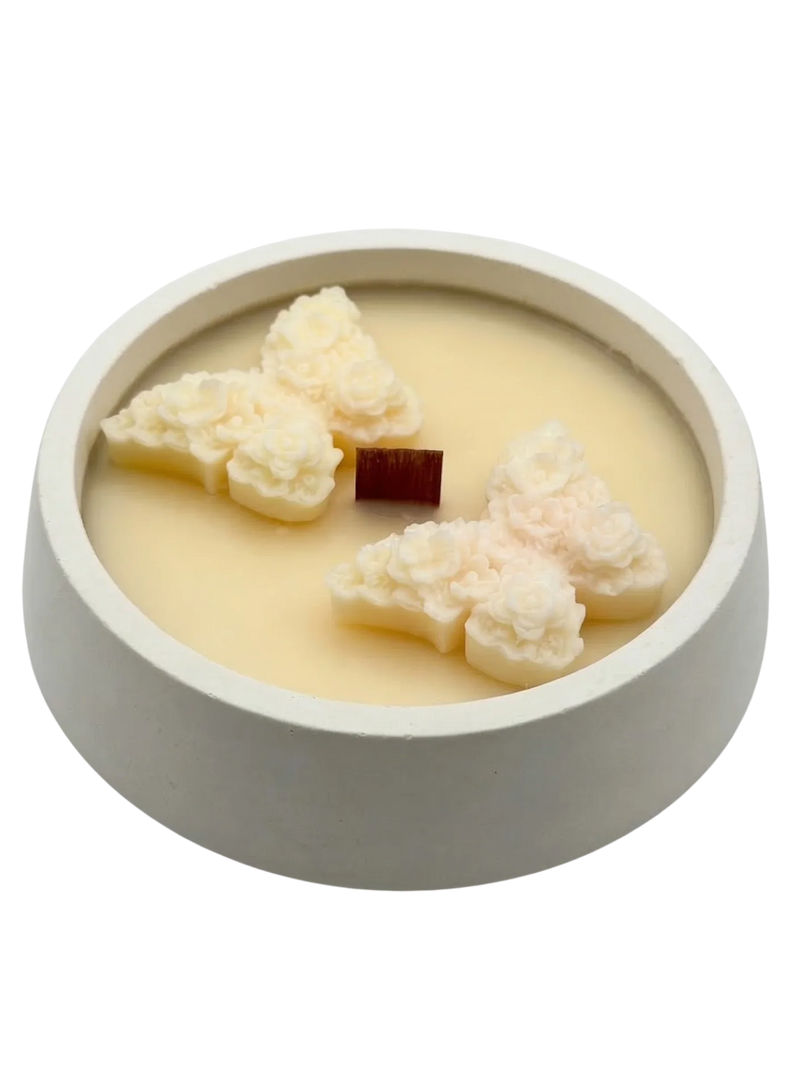 Handmade soy candle with floral wax accents in a minimalist concrete bowl, Scandinavian home décor