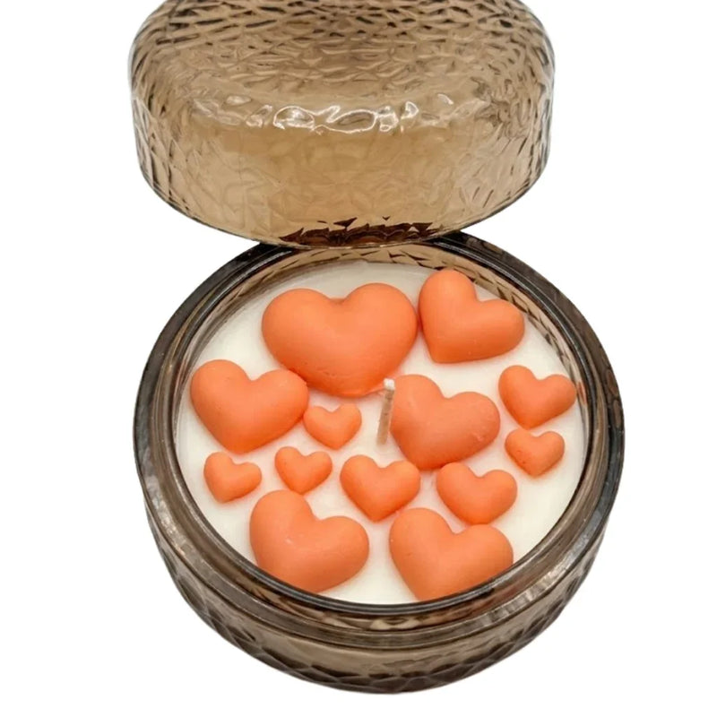 Handmade soy candle with orange heart wax melts in textured glass jar, Scandinavian home décor