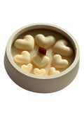 Handmade soy candle with heart-shaped wax melts and wooden wick in ceramic container