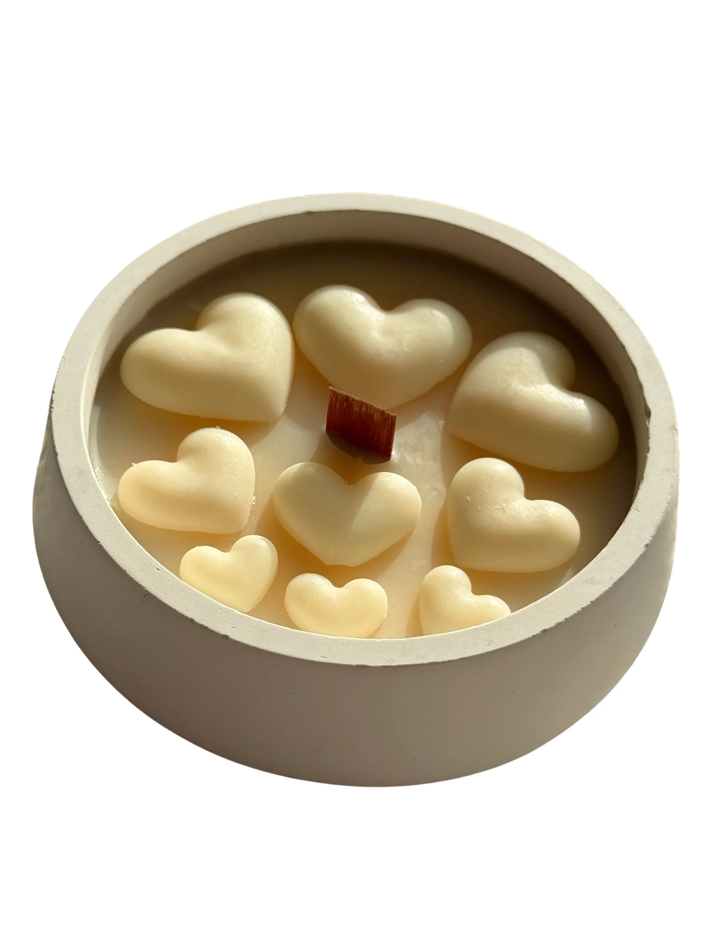 Handmade soy candle with heart-shaped wax melts and wooden wick in ceramic container