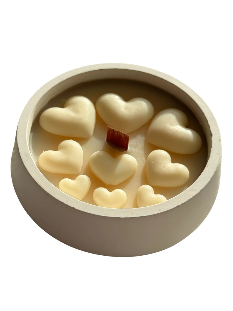Handmade soy candle with heart-shaped wax melts and wooden wick in ceramic container