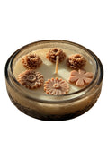 Handmade soy candle with floral wax decorations in a vintage glass jar, Scandinavian home decor