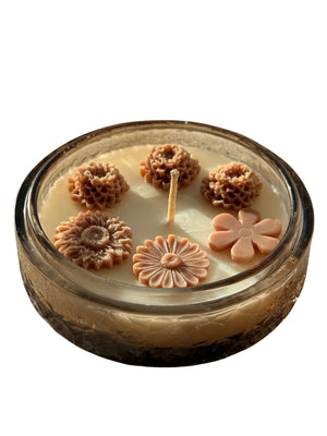 Handmade soy candle with floral wax decorations in a vintage glass jar, Scandinavian home decor