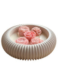 Handmade soy candle with pink rose blooms in a ribbed ceramic bowl, Scandinavian home décor