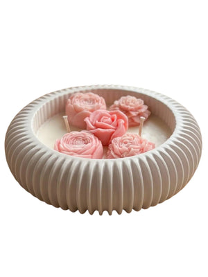 Handmade soy candle with pink rose blooms in a ribbed ceramic bowl, Scandinavian home décor