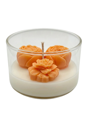 Handmade soy candle with orange rose wax flowers in clear glass jar, Scandinavian home décor