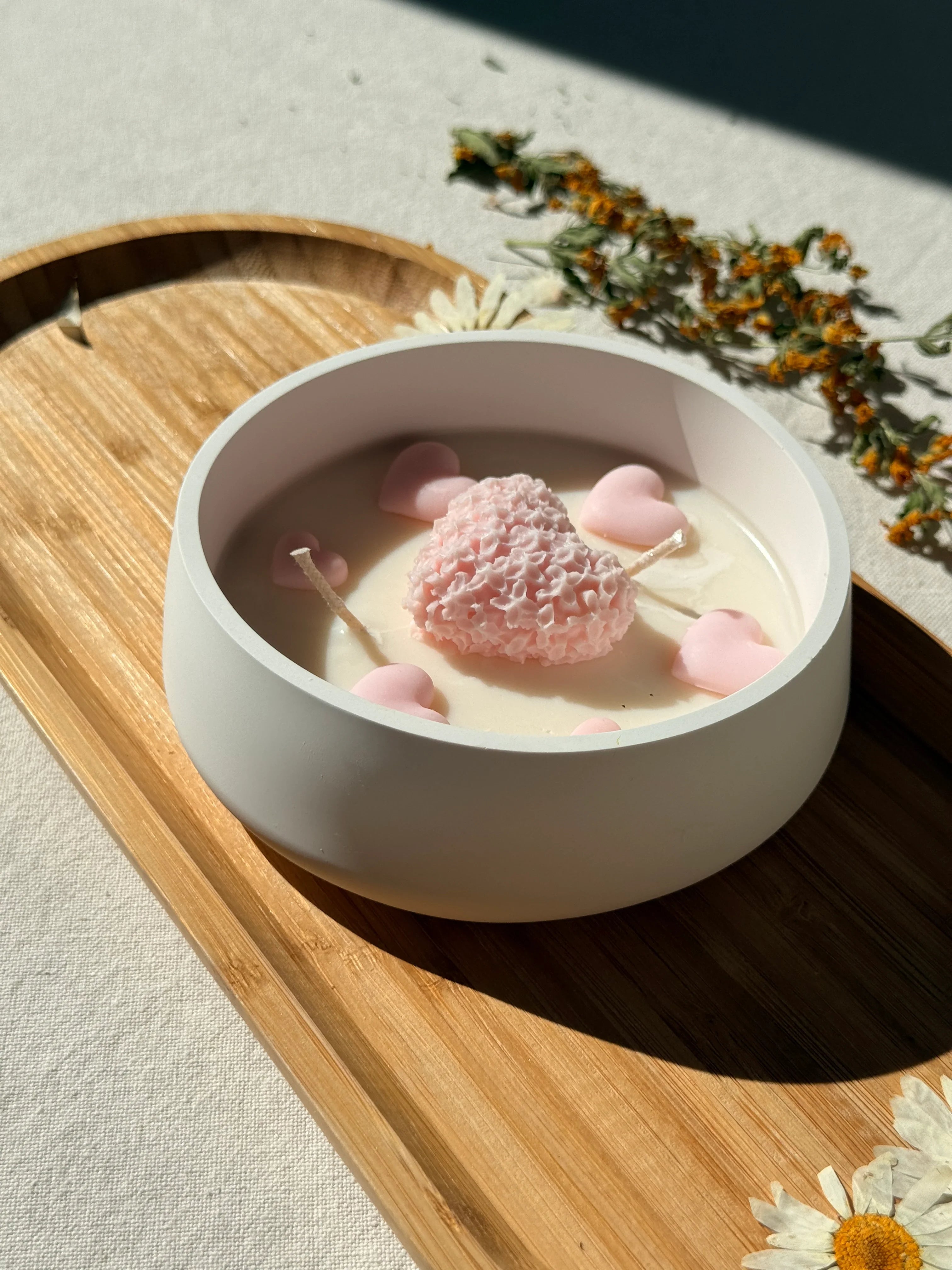 Handmade soy candle with pink heart decor in white ceramic bowl, Scandinavian home décor style