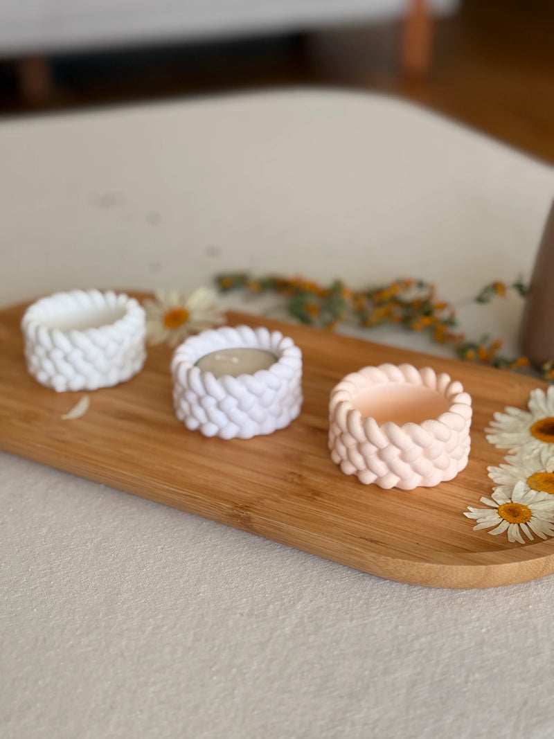 Handmade braided soy candles in white and blush on wooden tray with daisies, Scandinavian home décor