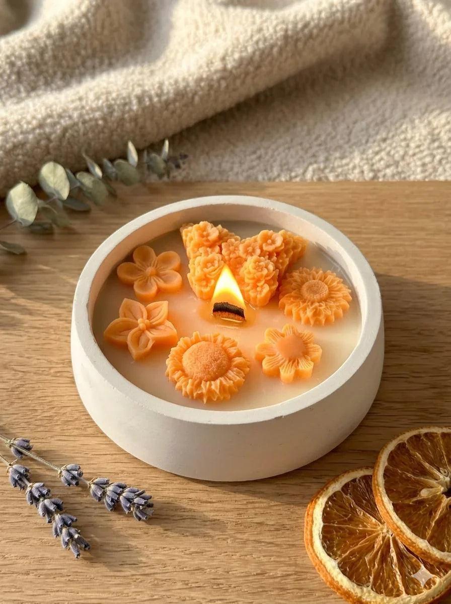 Handmade soy candle with orange flower wax melts, lavender, and dried orange slices on wood — cozy Scandinavian home décor