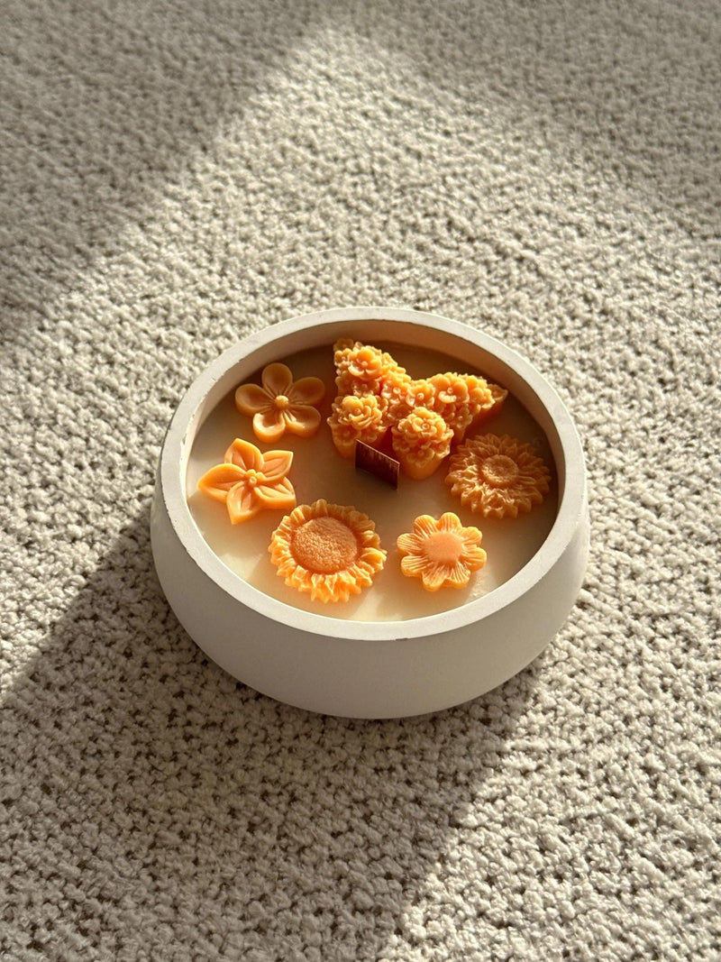 Handmade soy candle with orange flower wax melts in white ceramic bowl, Scandinavian home decor