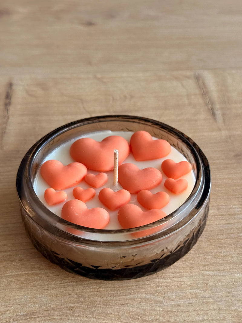 Handmade soy candle with coral hearts in glass jar, Scandinavian home decor