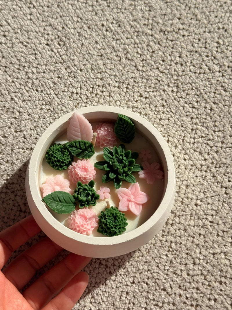 Handmade soy candle with pink flowers and green succulents, Scandinavian home décor
