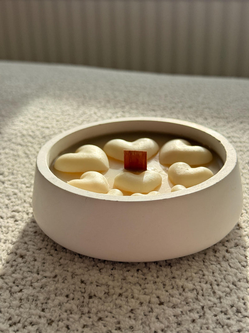 Handmade soy candle with heart-shaped wax and wooden wick in minimalist white bowl, Scandinavian home décor