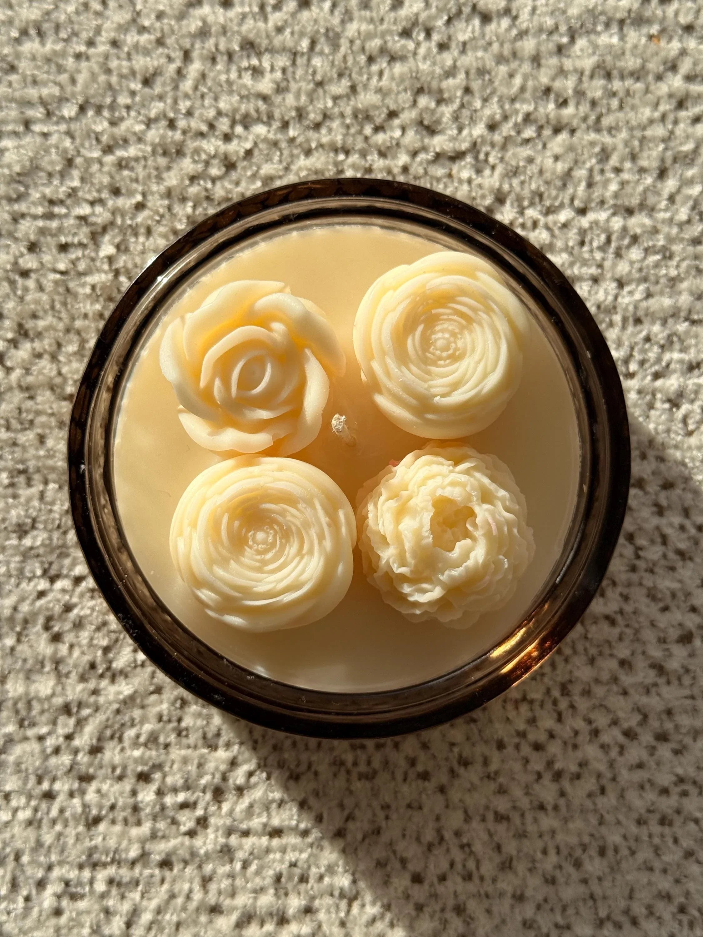 Handmade soy candle with four sculpted rose blooms in amber glass, Scandinavian home decor